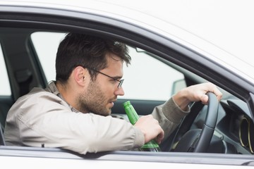 Man drinking beer while driving