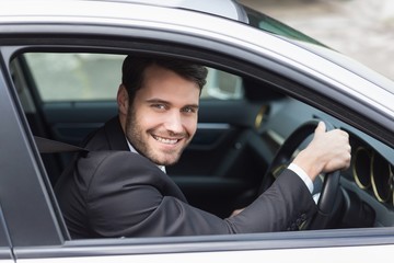 Happy businessman in the drivers seat