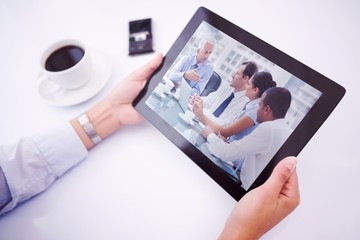 Composite image of man using tablet pc