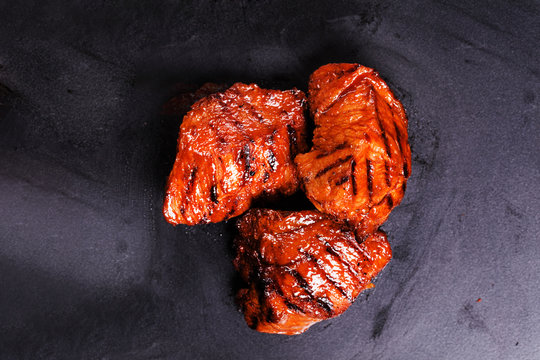 slices of beef grilled on a black background
