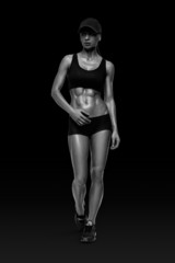 Fitness sporty woman walking on black background
