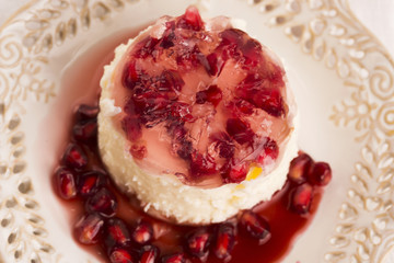 coconut panna cotta dessert with pomegranate
