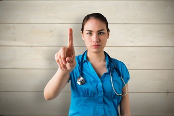 Composite image of serious doctor pointing - Powered by Adobe