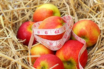 measure tape and red apple