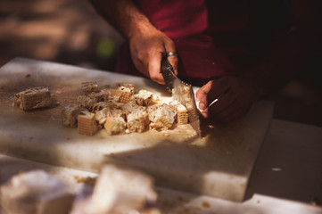 men cutting italian sweets on market
