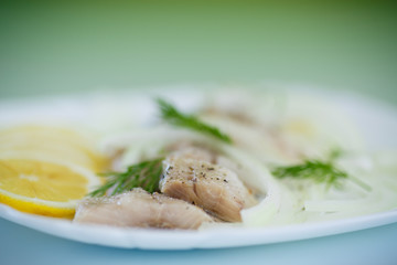 pieces of salted herring with onions