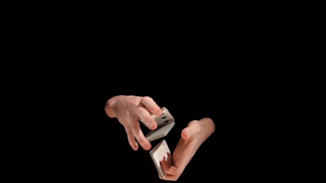 Wizard showing a trick with deck of cards on black background