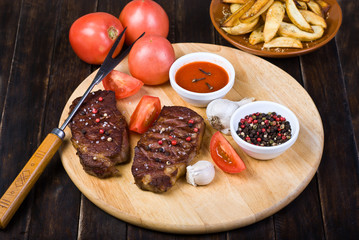 Beef Steaks with Sauces, French Fries and Vegetables
