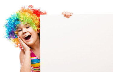 Girl in clown is holding blank banner