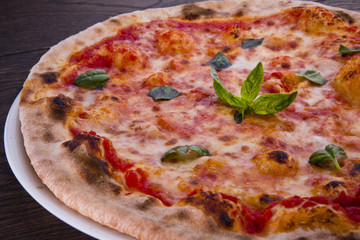 Delicious italian pizzas served on wooden table