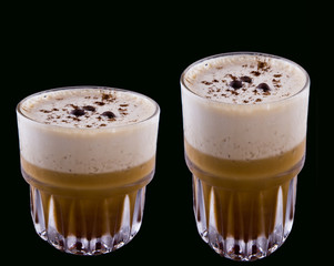 Cold coffee with ice in glass isolated on black