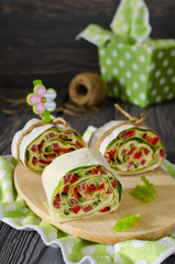 Rolls of bread with vegetables, cheese and sausage