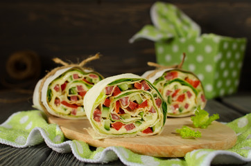 Rolls of bread with vegetables, cheese and sausage