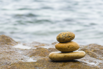 Stack of stones with sea water background
