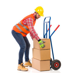 Delivery man place package on delivery cart