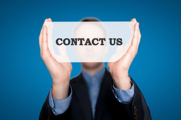 Businessman Holding Sign Contact Us. Blue background