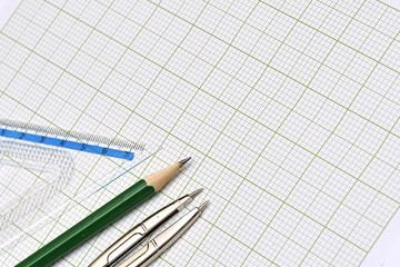 Mathematical instruments and pencil on graph paper. - 78383509