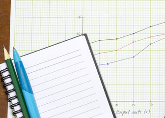 Pen and pencil on blank note book with graph paper.