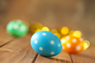 Easter background - colored eggs on wooden boards