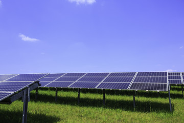Modern solar panels in a beautiful green field