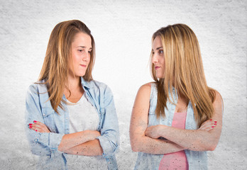 Friends with arms crossed over white background