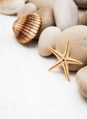 Fototapeta na wymiar marine background with pebbles and starfish