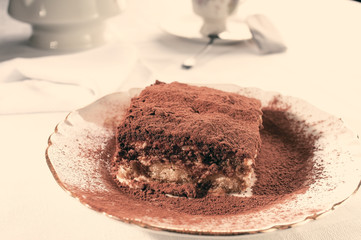 Slice of homemade tiramisu dessert in instagram warm tone
