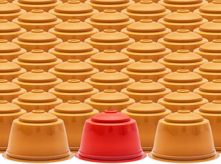 Coffee capsules, one red against set