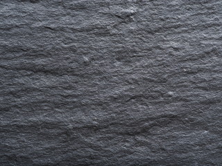 Rough graphite background. Closeup shot.