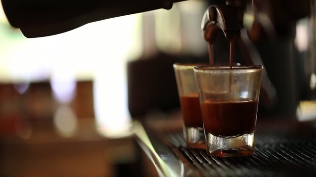espresso pouring from machine to cup