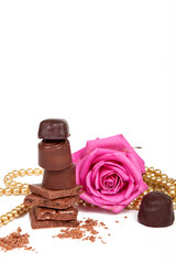 Rose and chocolates on a white background