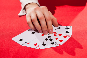 Woman's hand holding playing cards