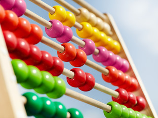 Coloured children abacus in front of blue sky