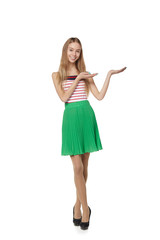 Smiling woman showing open hand palm with copy space for product