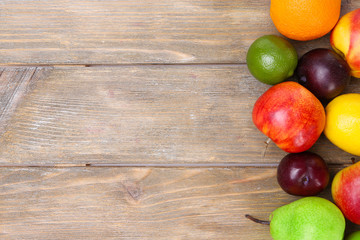 Assortment of juicy fruits on wooden background