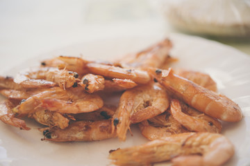 closeup of a plate with spanish shrimps cooked with garlic and p