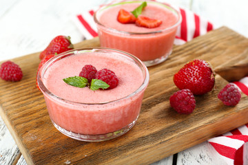 Delicious berry mousse in bowls on table close-up