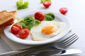 Bacon and eggs on color wooden table background