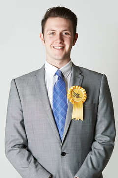 Portrait Of Liberal Democrat Politician Wearing Yellow Rosette