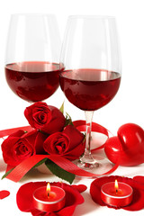 Composition with red wine in glasses, red roses, ribbon and