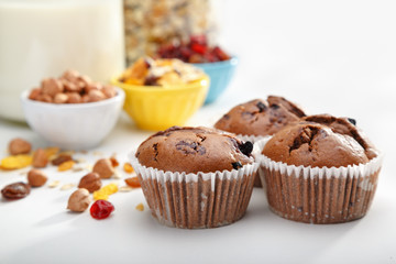 Delicious chocolate muffins on wooden board 