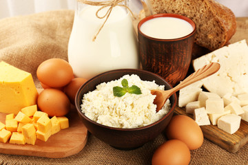 Tasty dairy products with bread on table close up