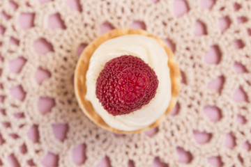 Sweet tartlets filled with cream and blueberry, raspberry and ma
