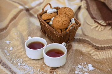 Two cups of tea with  cookies