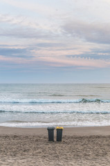 Two trash cans on the beach