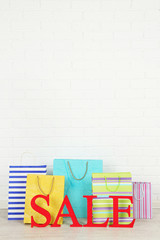 Sale with bags on floor on bright background
