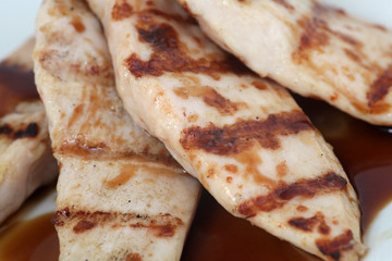close up of grilled chicken breast fillet with sauce