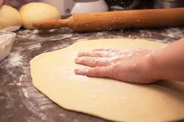 Close Up of female hand kneading dough