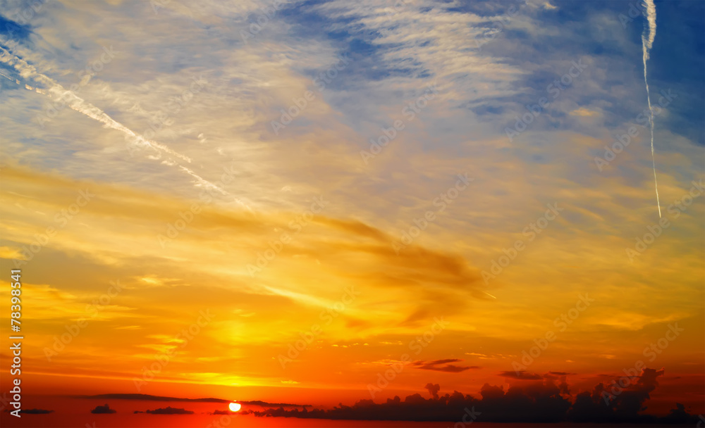 Wall mural orange, yellow and blue scenic sky at dusk