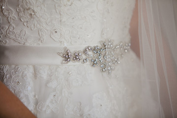 Belt with shine rhinestones on a luxurious white wedding dress